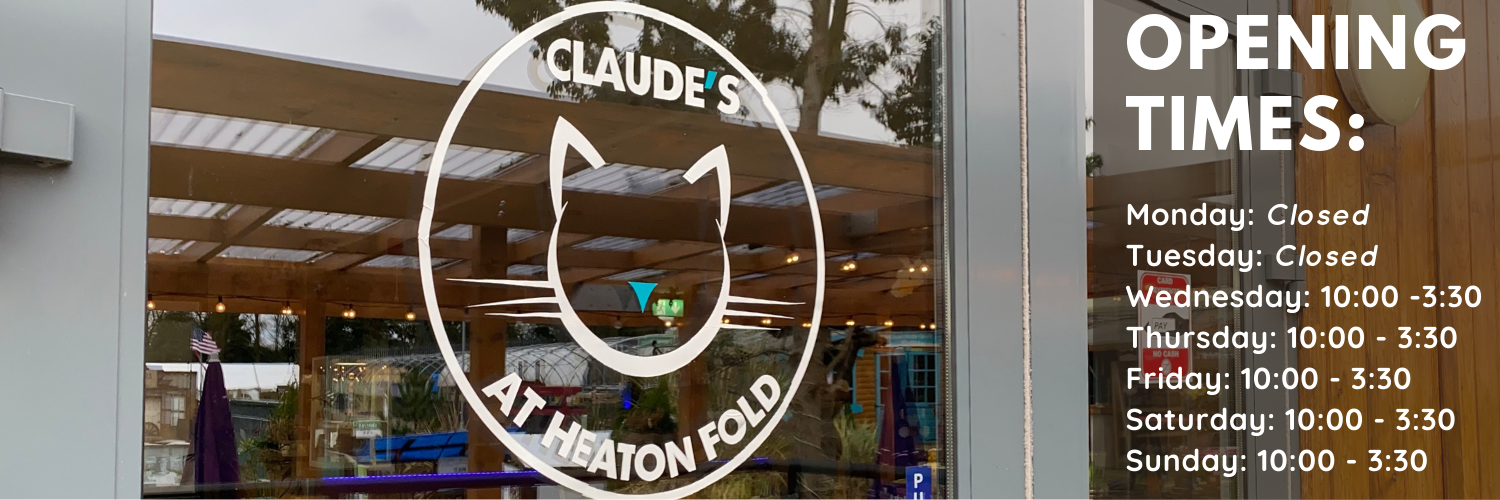 A picture of the front door to Claude's Cafe, with text to the side saying Opening Times, Monday and Tuesday Closed, Wednesday to Sunday the Cafe is open from 10 o'clock to 3:30 pm. 