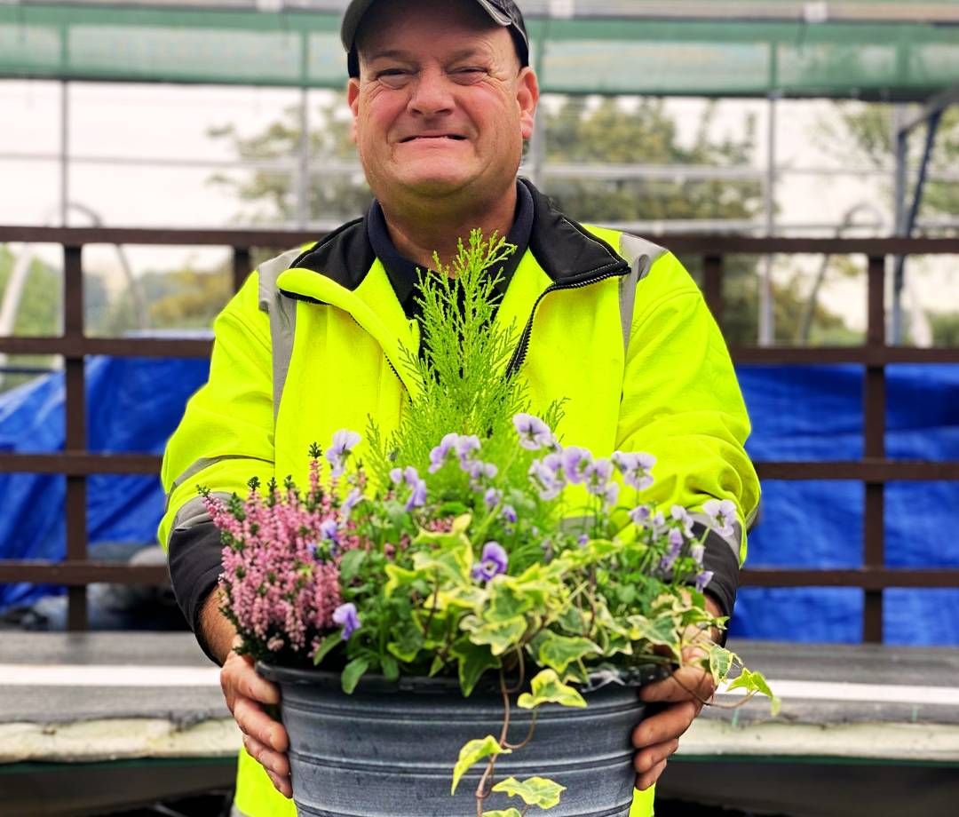 A picture of our student, Andrew, with a planter.